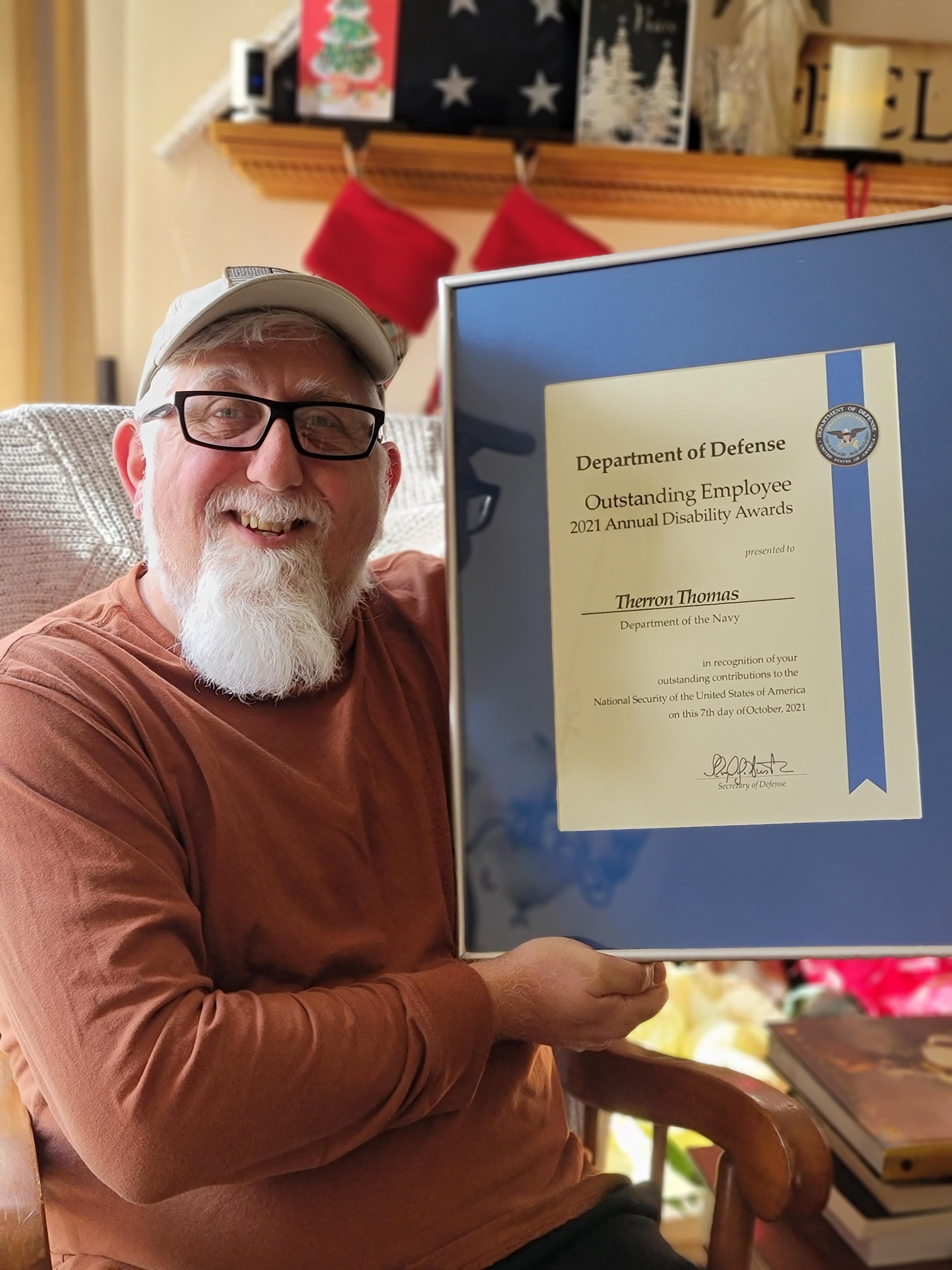Figure 1: Therron Thomas with his Secretary of Defense (SecDef) Award for Outstanding Department of Defense (DoD) Employees and Service Members with Disabilities.